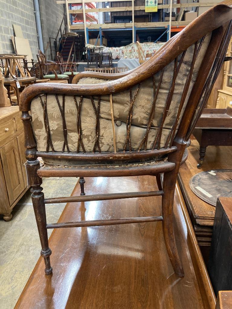 A late Victorian walnut caned seat back armchair